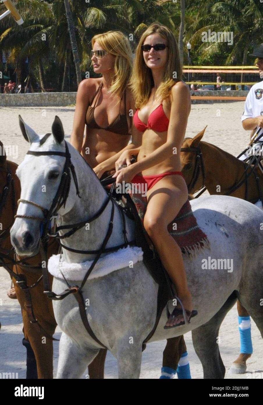 Bikini Clad Girls mount horses to ride in the parade for the launch of
