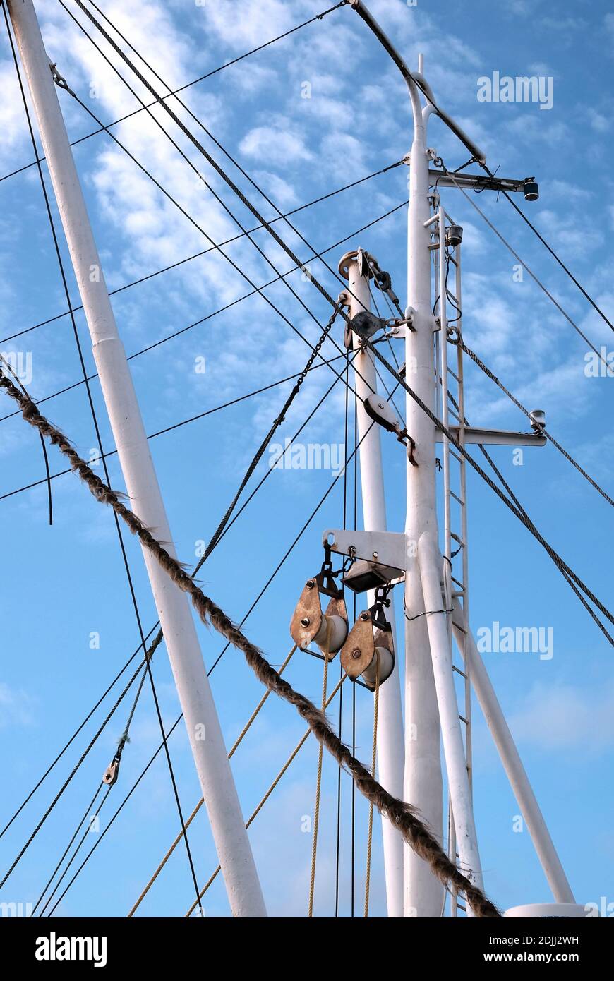 A vertical shot of a boat sailing in the waters under a blue sky Stock ...