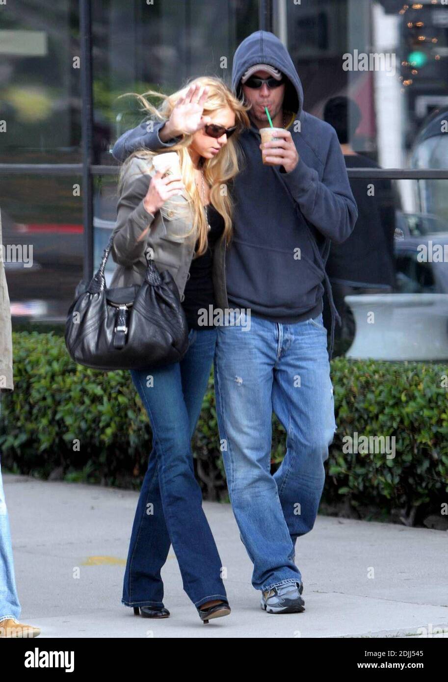 Anna Kournikova and Enrique Iglesias take a romantic stroll through Los Angeles, Ca.  Anna cuddled up under Enrique's arm as they walked, wearing matching jeans and sunglasses. 4/7/05 Stock Photo
