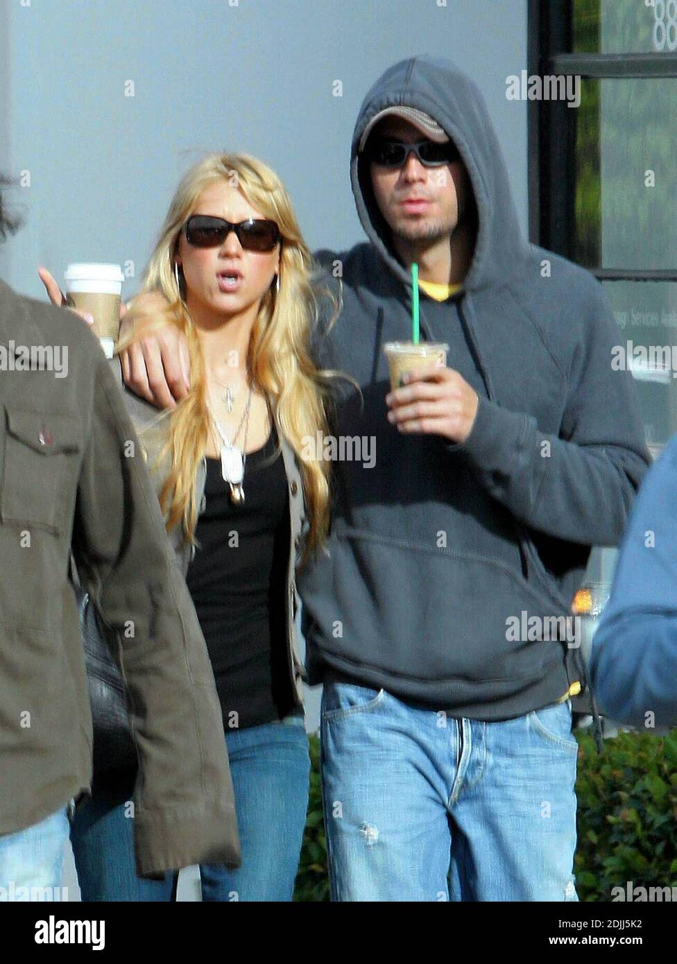 Anna Kournikova and Enrique Iglesias take a romantic stroll through Los Angeles, Ca.  Anna cuddled up under Enrique's arm as they walked, wearing matching jeans and sunglasses. 4/7/05 Stock Photo