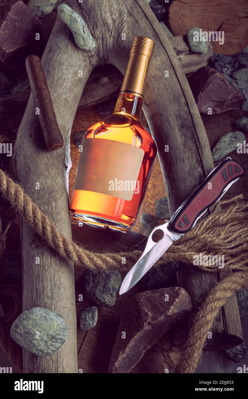 Concept composition with cognac and cigar. Brandy and knife. Vertical frame. Stock Photo