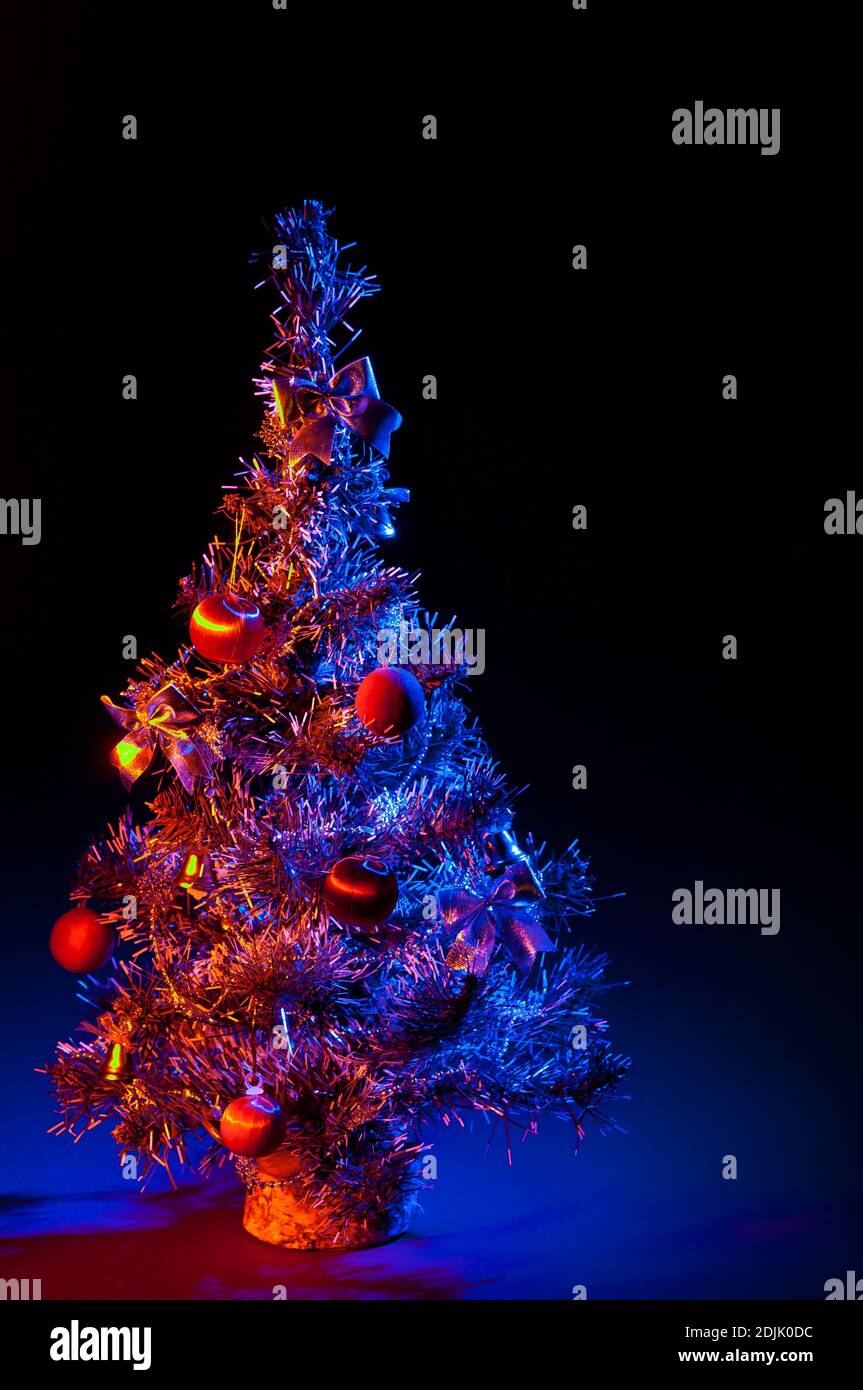 Christmas tree is richly decorated with a black background Stock Photo ...