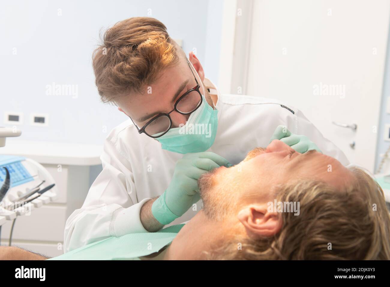 Dentist giving dental treatment on a patient with bad teeth Stock Photo