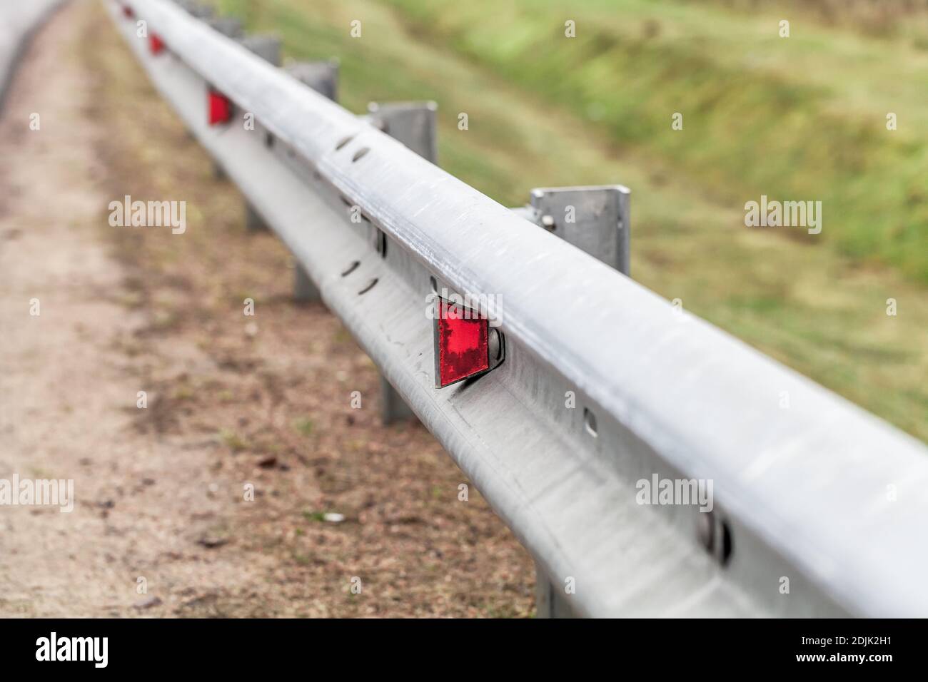 Metal guardrail mounted on a highway roadside, safety equipment Stock Photo