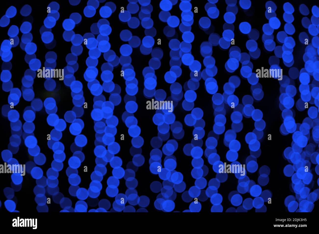 blue blurry Christmas lights on the streets. holiday night background