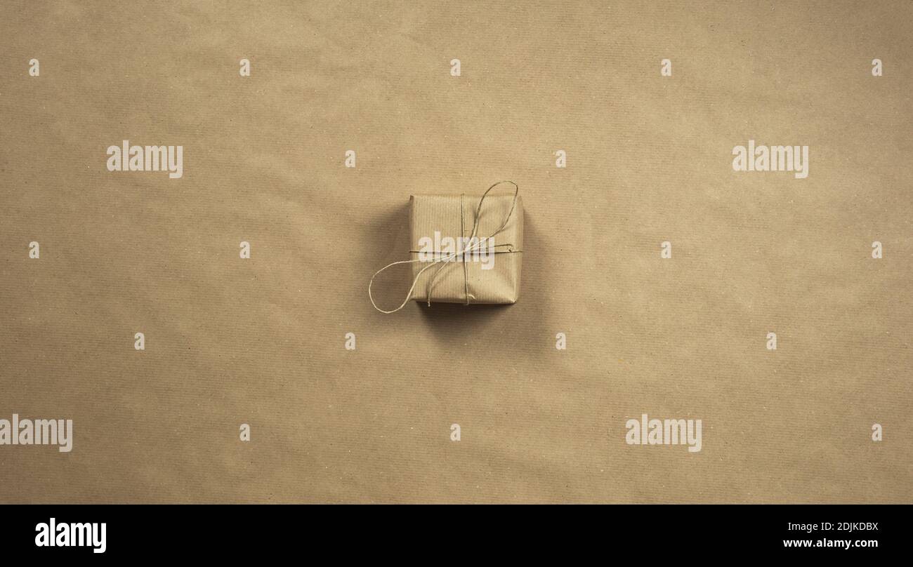 Paper Box With Rope Two gift boxes wrapped in plain brown recycled paper with rope on brown ...