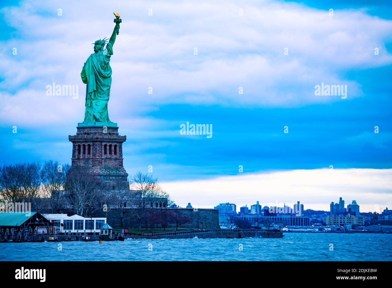 The Statue of Liberty over the New York cityscape from Black Tom Island Stock Photo