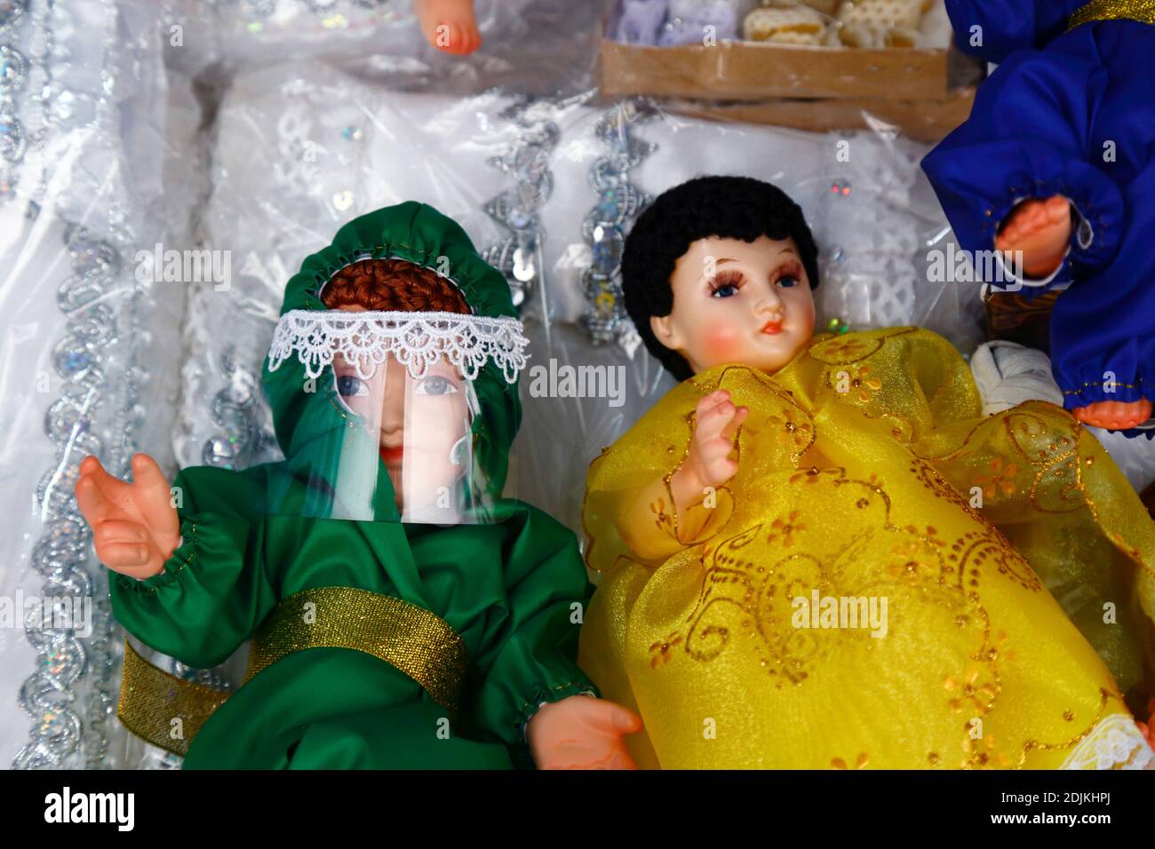 14th December 2020, LA PAZ, BOLIVIA: Baby Jesus figure (called Niño in Spanish) for nativity scenes wearing face mask and protective clothing against the covid 19 coronavirus on sale in a Christmas market. Nativity scenes are an important Christmas decoration in houses and public places in Latin America, and also Spain (where the tradition comes from).  Large numbers of figurines for nativity scenes are sold in Christmas markets; niños wearing protection against the covid 19 coronavirus are a new option this year alongside traditionally dressed niños as a result of the pandemic. Stock Photo