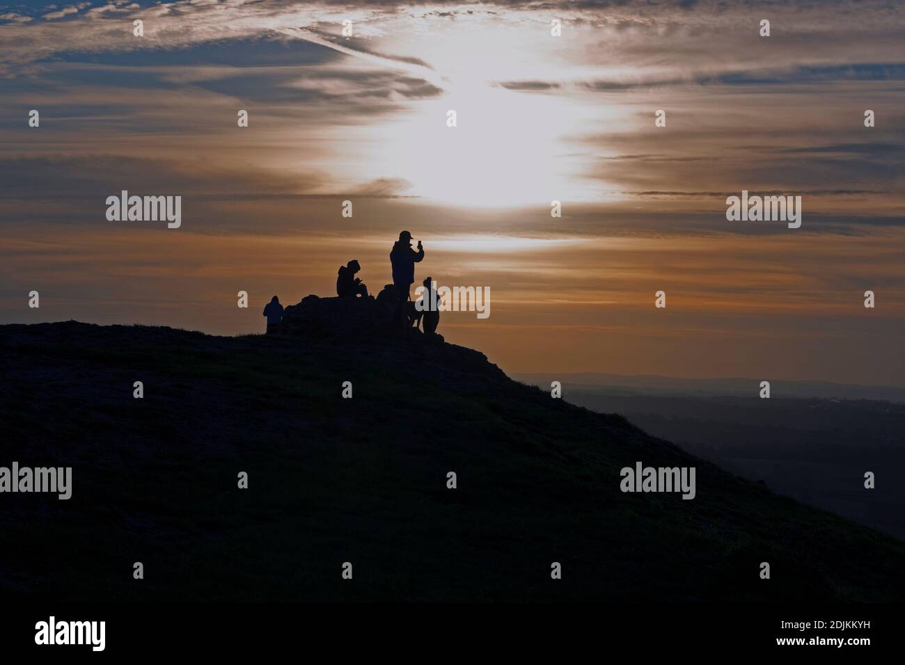 Friends catching the sunrise on Thorpe cloud in Dovedale Derbyshire Stock Photo