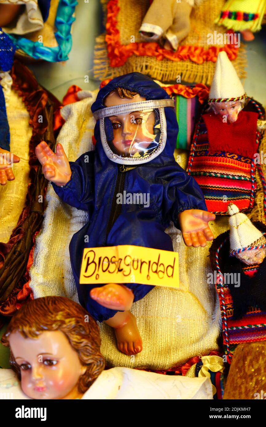 14th December 2020, LA PAZ, BOLIVIA: A baby Jesus figure (called Niño in Spanish) for nativity scenes wearing face mask and protective clothing against the covid 19 coronavirus in a Christmas market. Nativity scenes are a popular and important Christmas decoration in houses and public places in Latin America, and also Spain (where the tradition comes from).  Large numbers of figurines for nativity scenes are sold in Christmas markets; niños wearing protection against the covid 19 coronavirus are a new option this year alongside traditionally dressed niños as a result of the pandemic. Stock Photo
