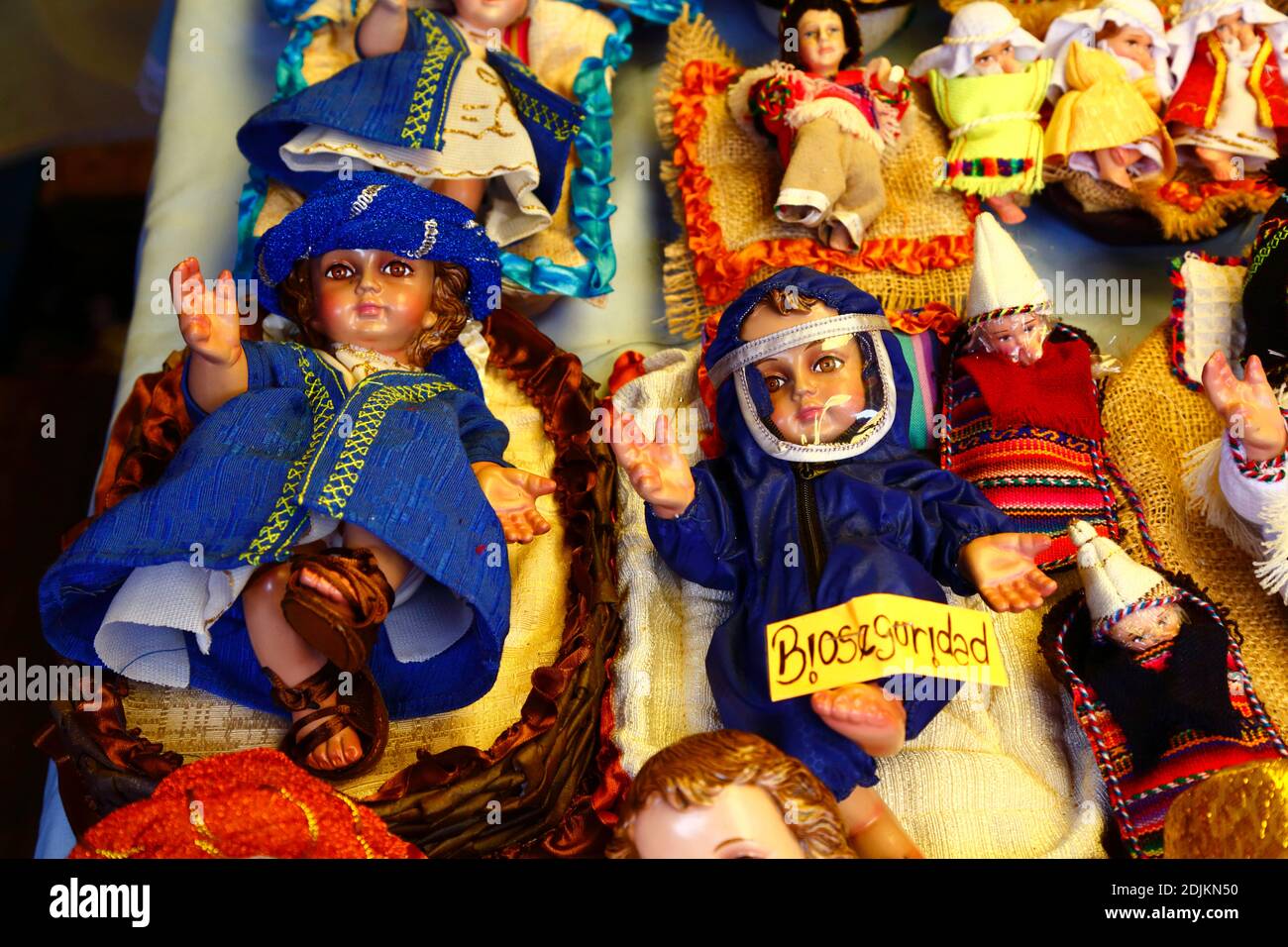 14th December 2020, LA PAZ, BOLIVIA: A baby Jesus figure (called Niño in Spanish) for nativity scenes wearing face mask and protective clothing against the covid 19 coronavirus in a Christmas market. Nativity scenes are a popular and important Christmas decoration in houses and public places in Latin America, and also Spain (where the tradition comes from).  Large numbers of figurines for nativity scenes are sold in Christmas markets; niños wearing protection against the covid 19 coronavirus are a new option this year alongside traditionally dressed niños as a result of the pandemic. Stock Photo