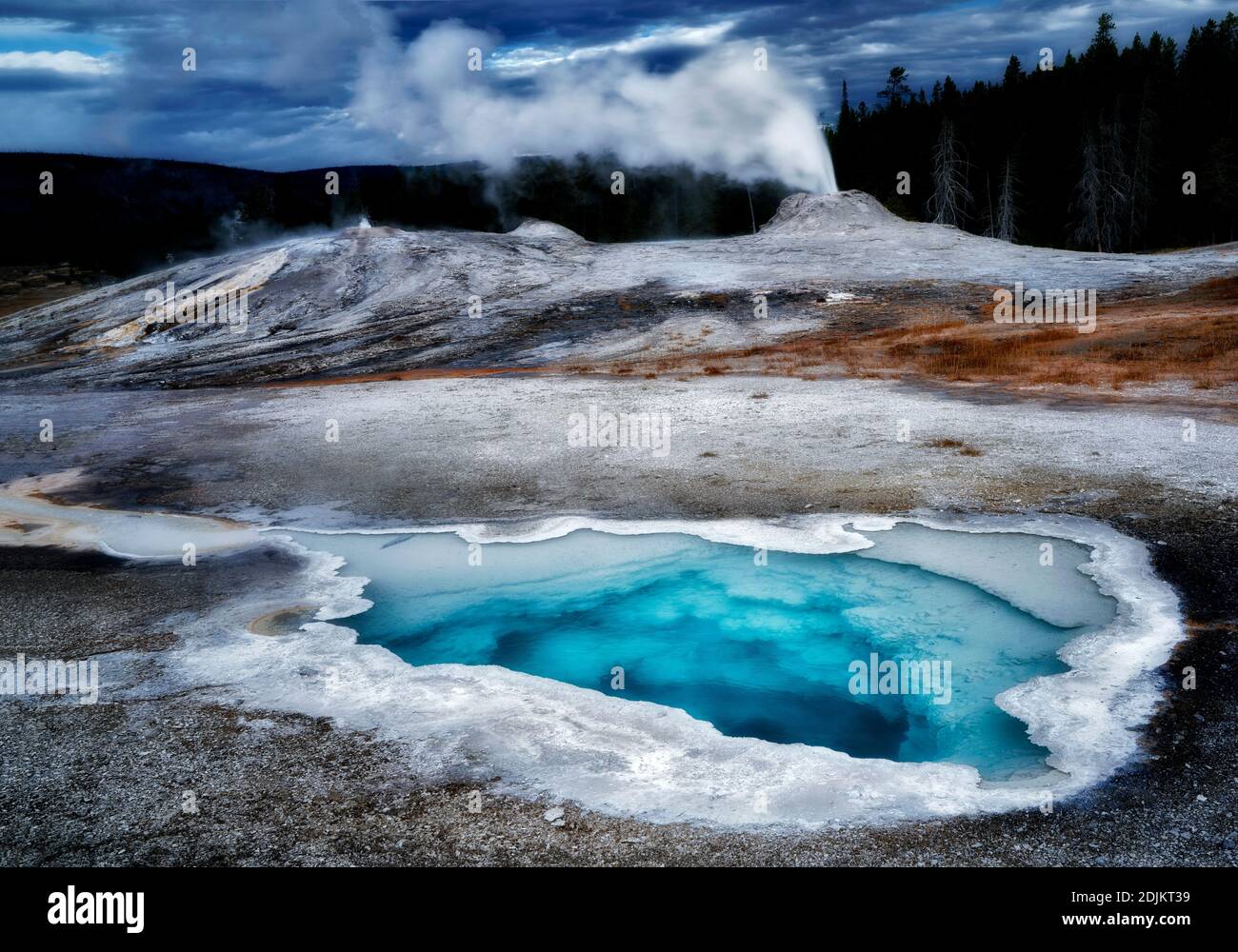 Heart Spring with Lion Gyser eruping. Yellowstone National Park, Wyoming Stock Photo