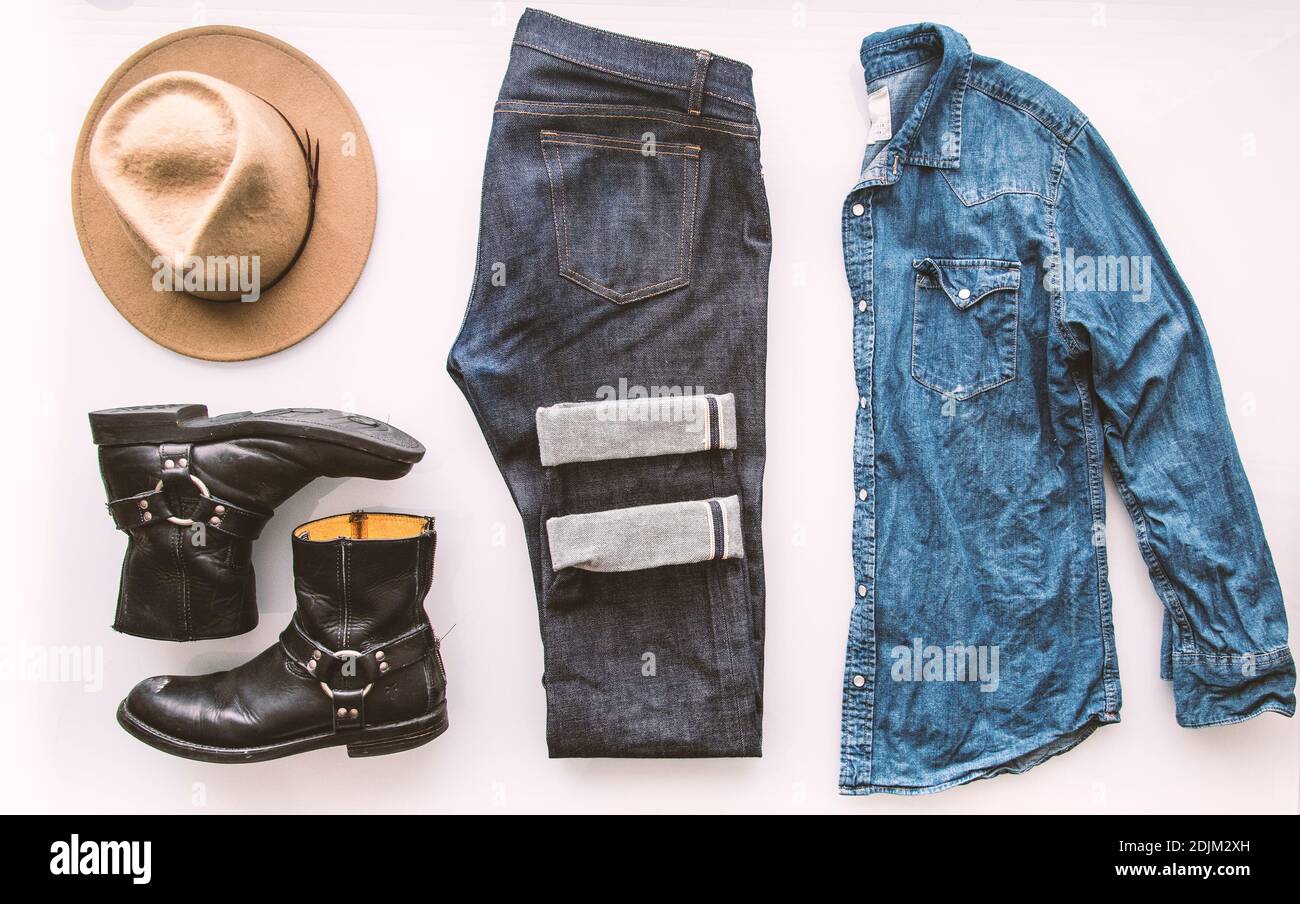 Mens fashion outfit grid. Simple white background. Denim jeans, denim shirt with pearl snap buttons, tan hat, black boots. Stock Photo