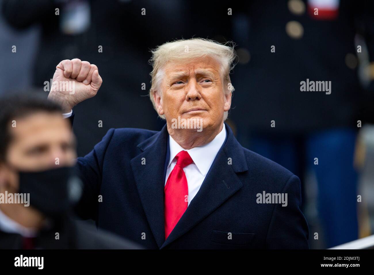 U.S. President Donald Trump holds up his fist as he arrives along the side-lines to visit with Army fans at the 121st Army-Navy football game at Michie Stadium December 12, 2019 in West Point, New York. The Army Black Knights shutout the Navy Midshipmen 15-0. Stock Photo