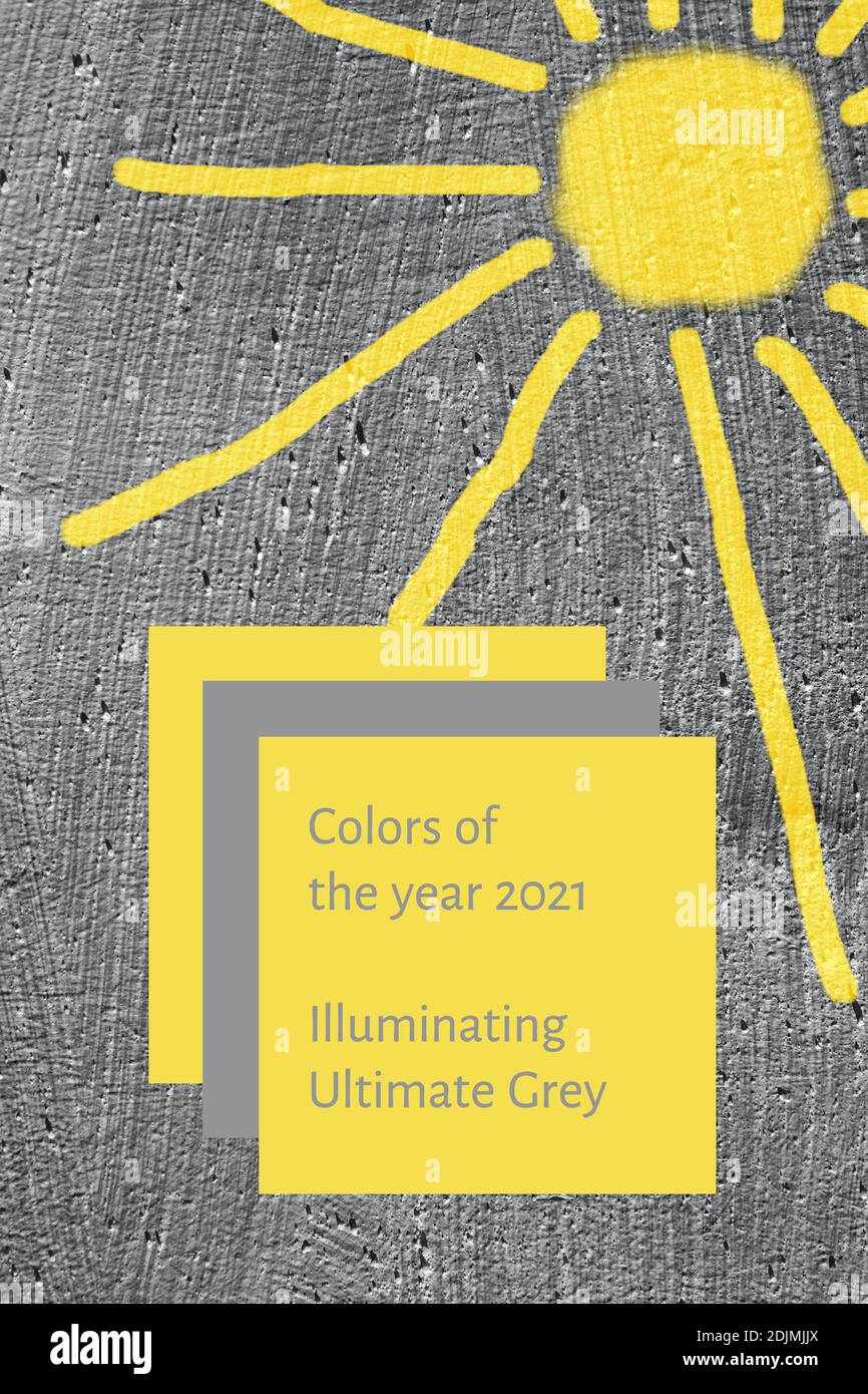 Background grey smooth concrete wall with painted yellow sun. Colors of year 2021. Vertical. Stock Photo