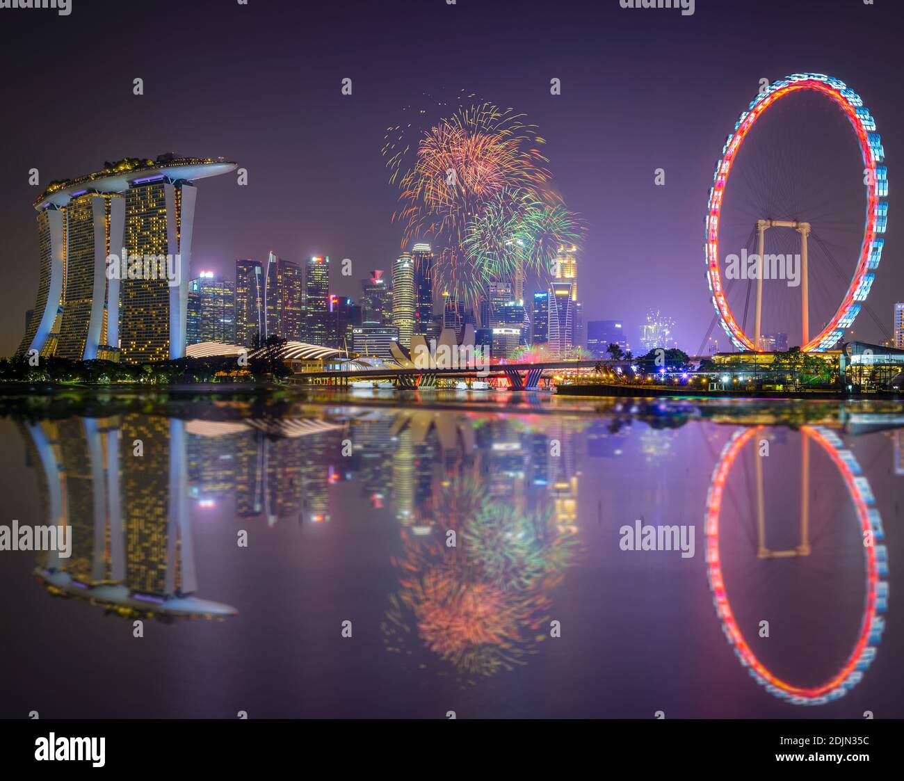 Firework Display By Lake And Marina Bay Sands In City At Night Stock