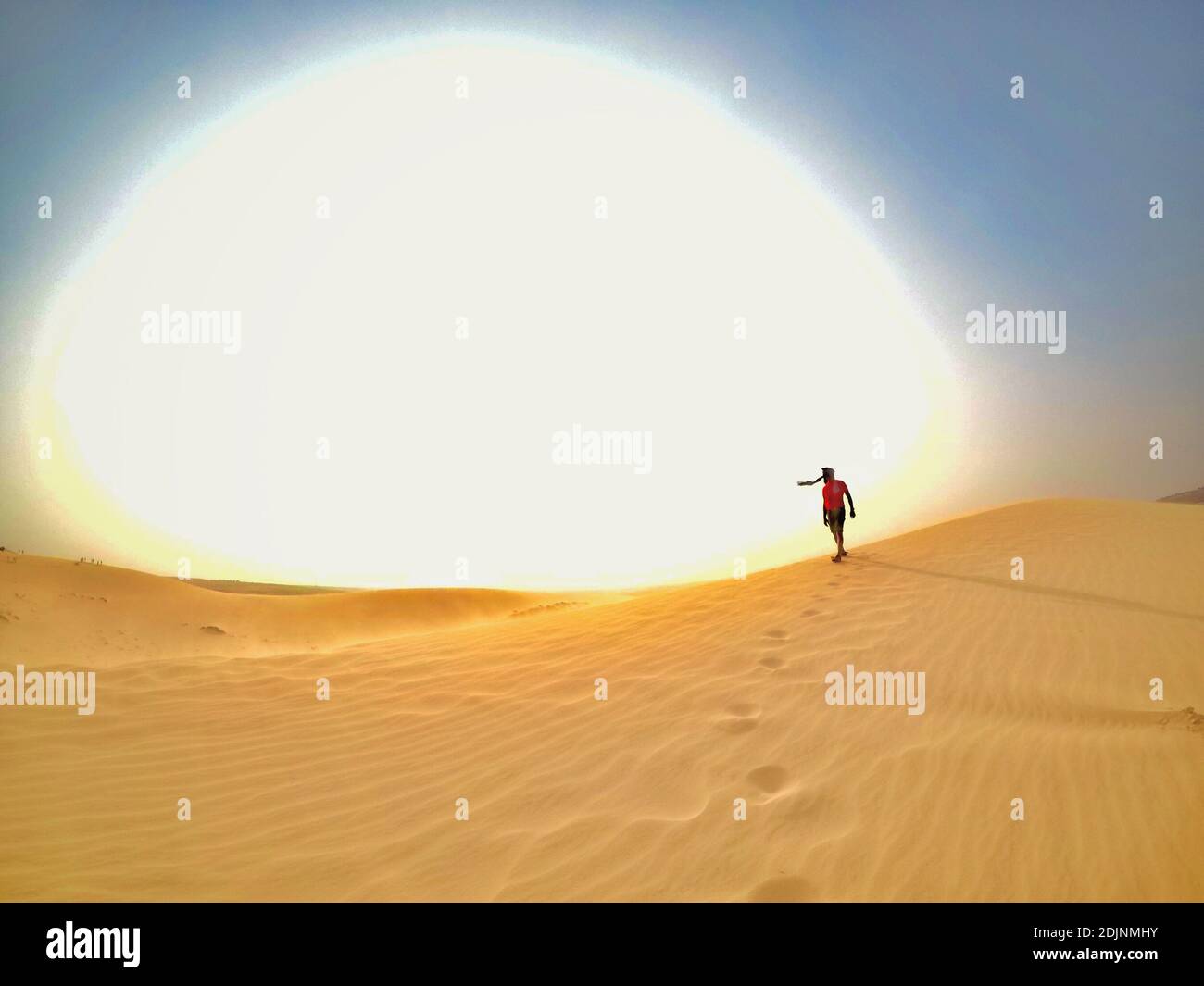 Mid Distance Of Man Walking On Sand Dune At Desert Stock Photo Alamy