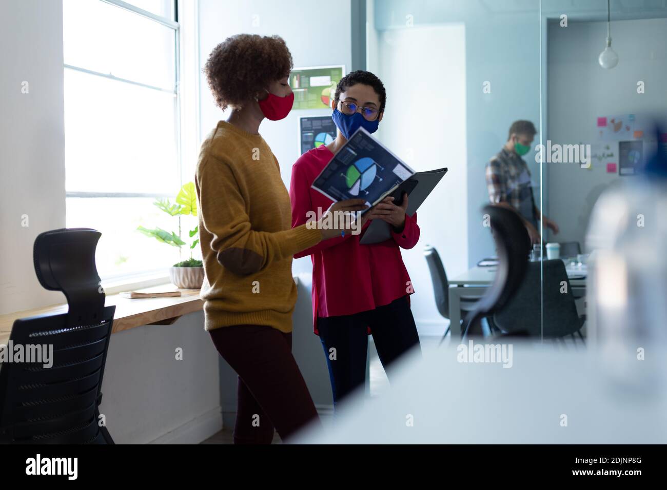 Two women wearing masks hi-res stock photography and images - Alamy