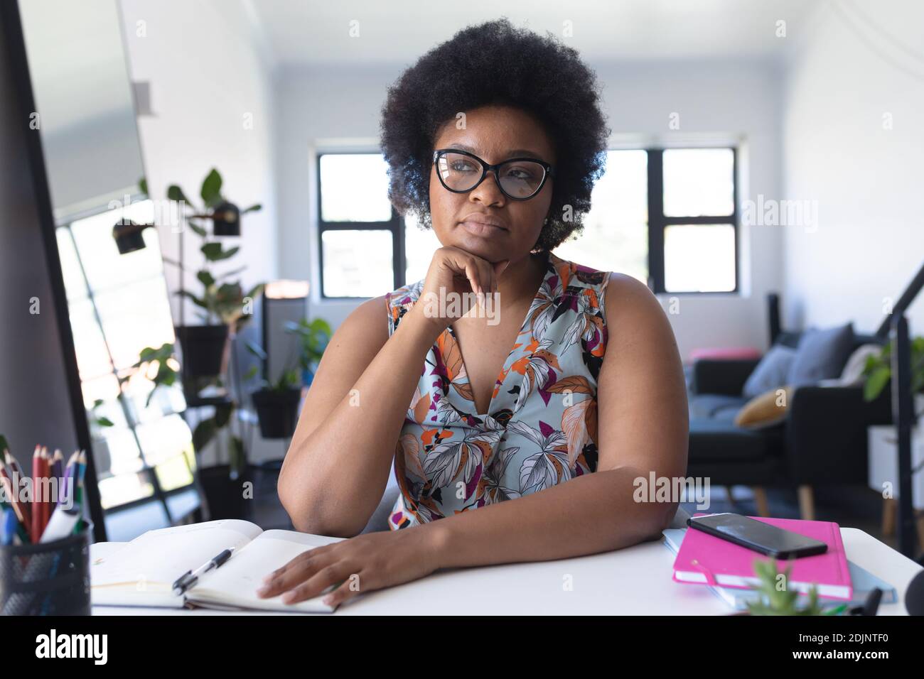 African american female vlogger recording a video rubbing her chin Stock Photo