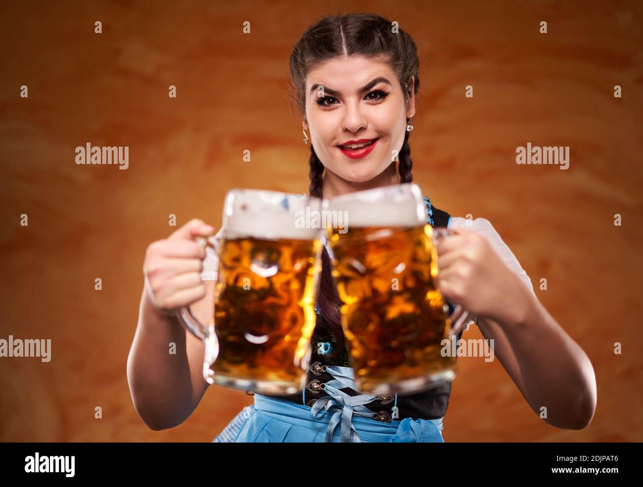 German girl in traditional costume with two large pints of lager Stock ...
