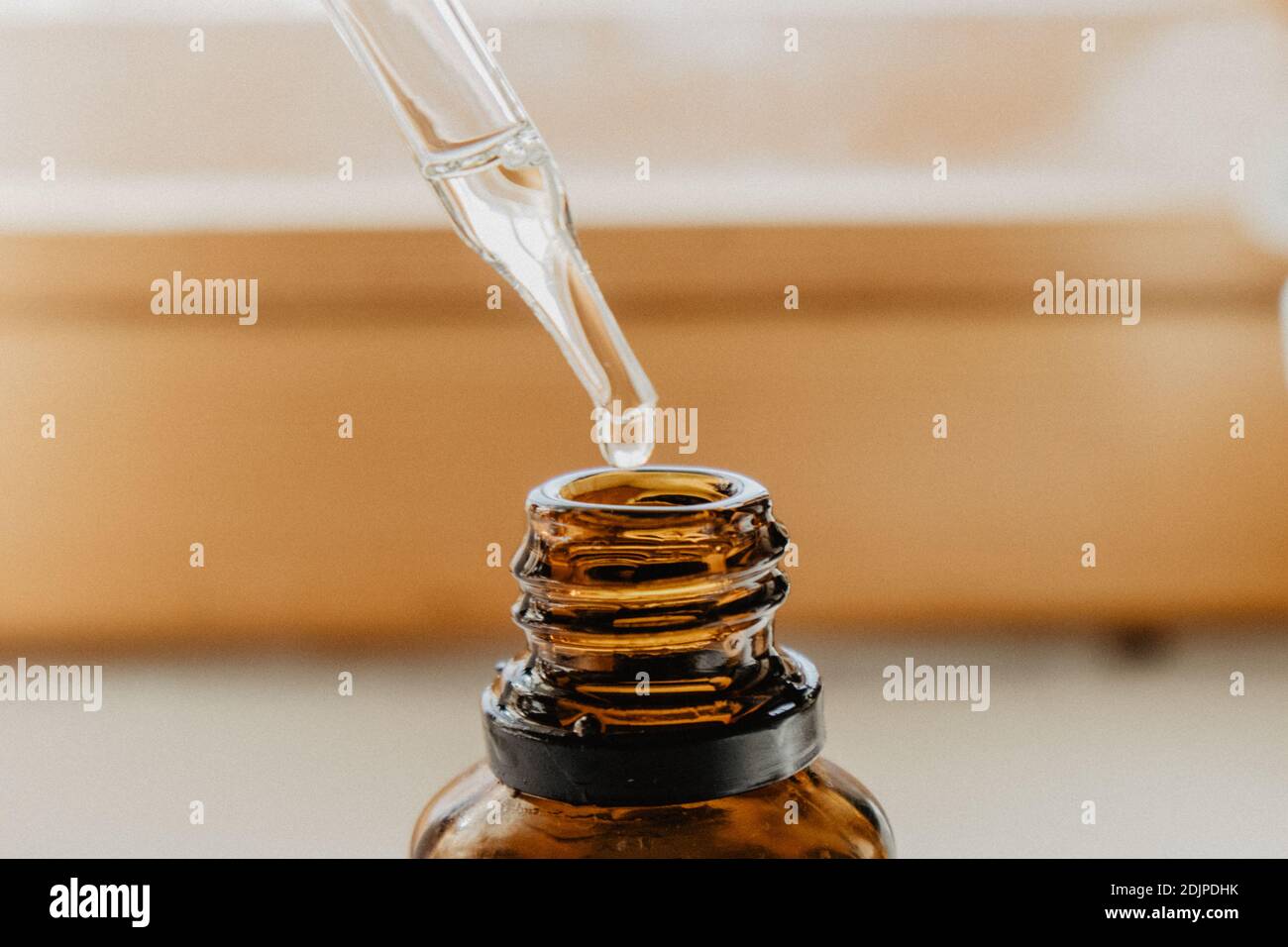 Close-up Of Pipette Over Bottle Stock Photo