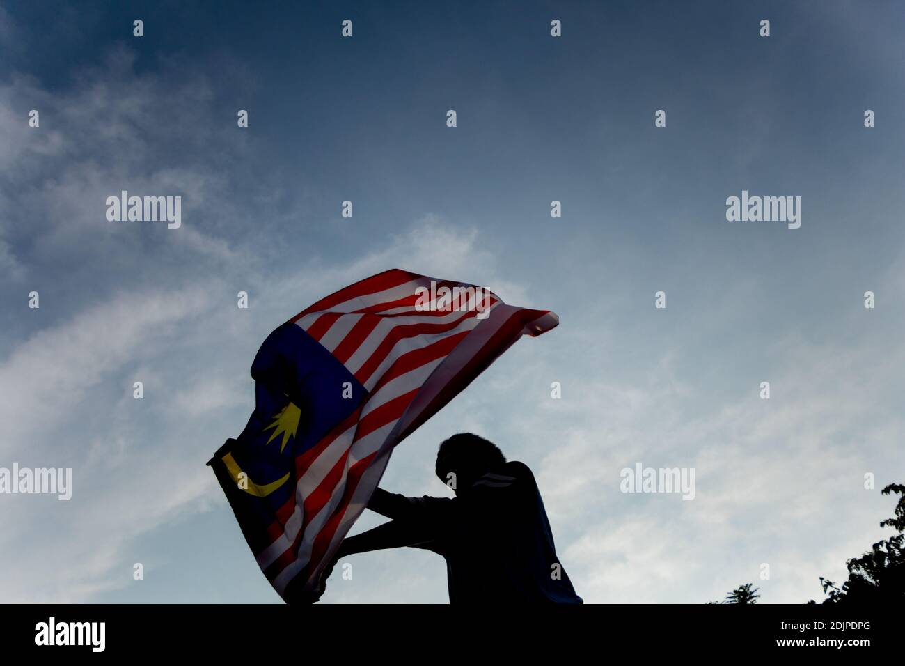Independence Day Concept A Happy And Proud Citizen Holding And Waving Malaysian Flag Sky Background Stock Photo Alamy