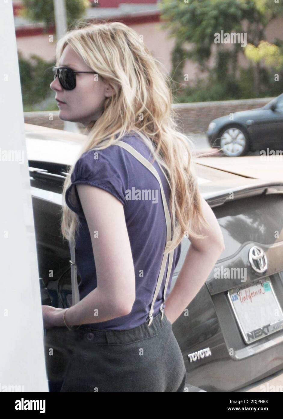 Exclusive!! Either slender Kirsten Dunst needs help keeping up her pants or she is starting a new fashion trend by wearing suspenders. The actress was spotted fueling her Hybrid car in Sherman Oaks, Ca.  9/21/06 Stock Photo