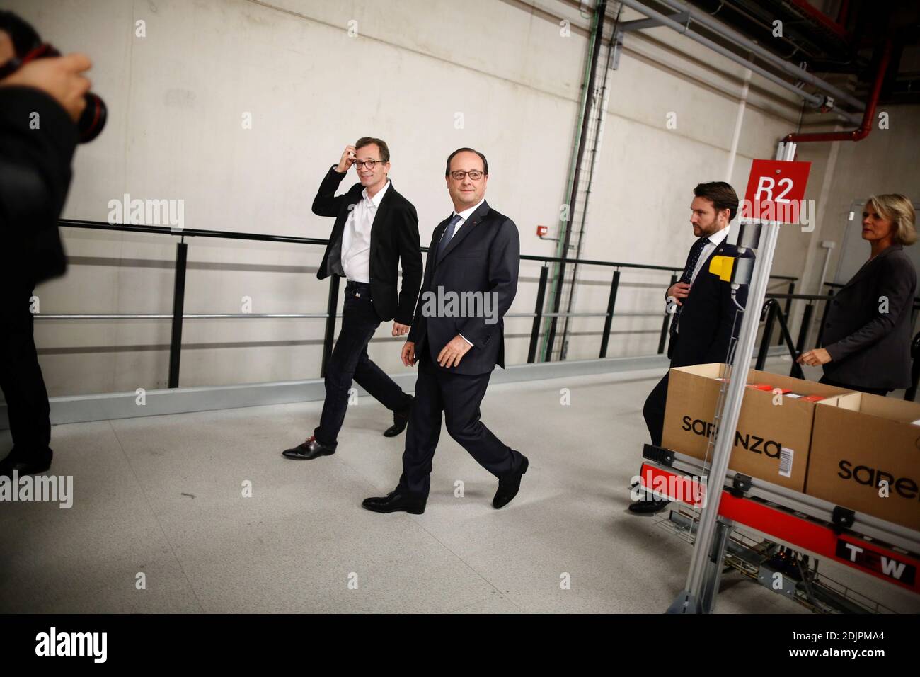 French President Francois Hollande along with Sarenza director of the Board  Stephane Treppoz tours the logistics warehouse of Sarenza, a French  e-Commerce company specializing in the online sale of shoes and accessories,