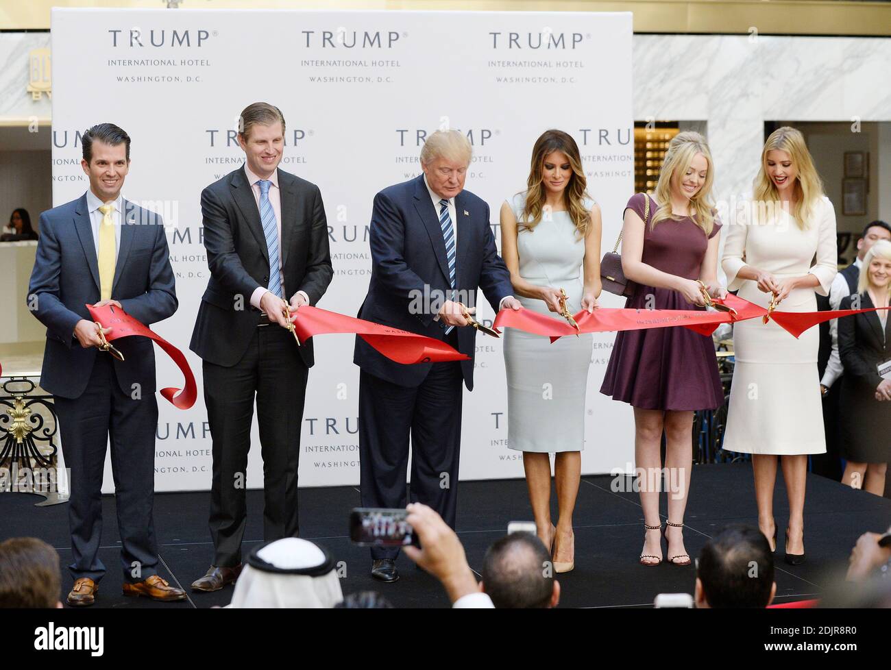 Republican presidential nominee Donald Trump (C) and his family (L-R) son  Donald Trump Jr, son Eric Trump, wife Melania Trump and daughters Tiffany  Trump and Ivanka Trump cut the ribbon at the
