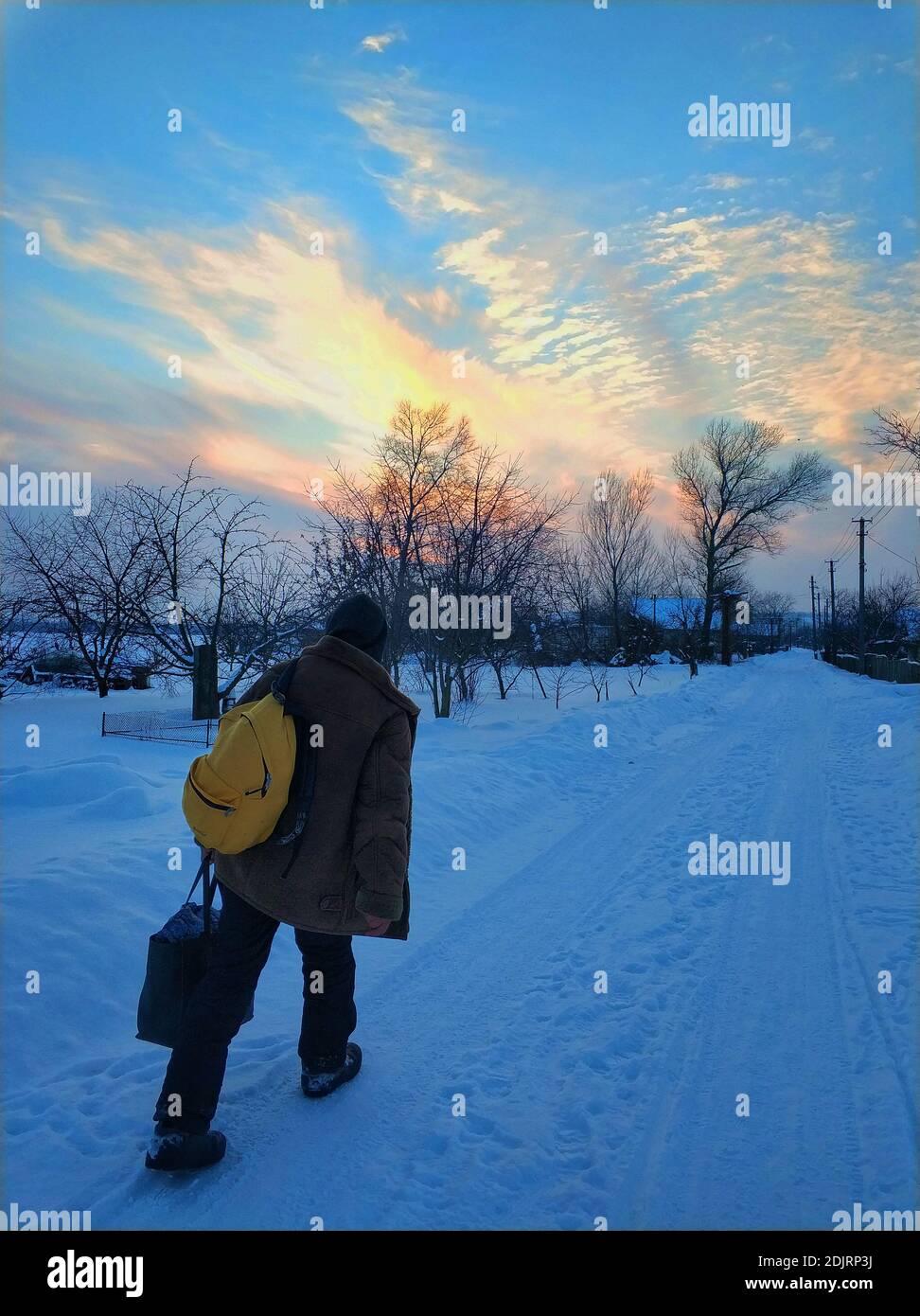 Man walks down snowy street hi-res stock photography and images - Alamy