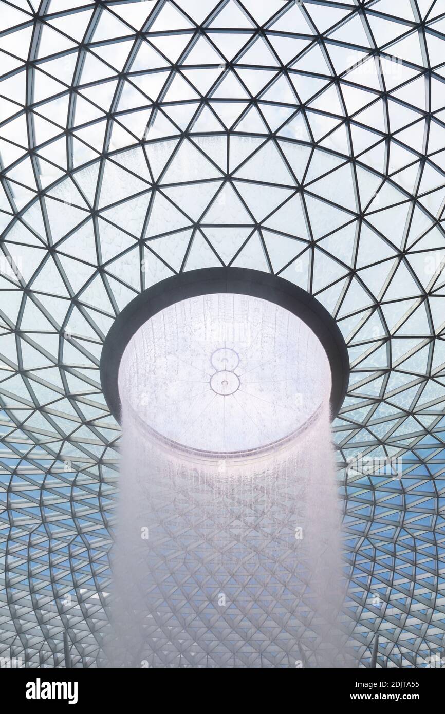 Singapore - October 21, 2019: The tallest indoor waterfall in the world, at Singapore International Airport, Jewel Changi Airport building, surrounded Stock Photo