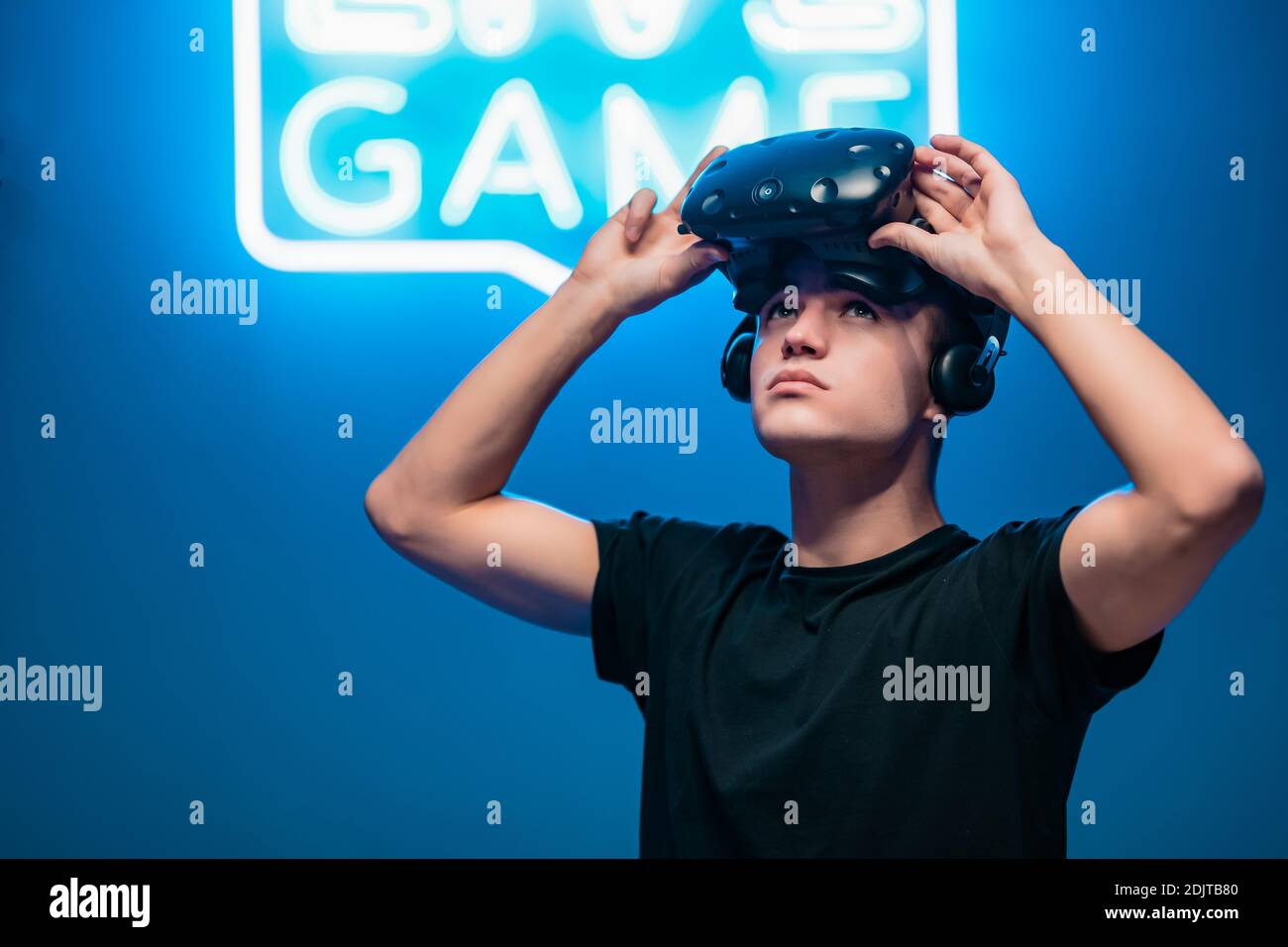 The young man raised his virtual reality glasses Stock Photo - Alamy