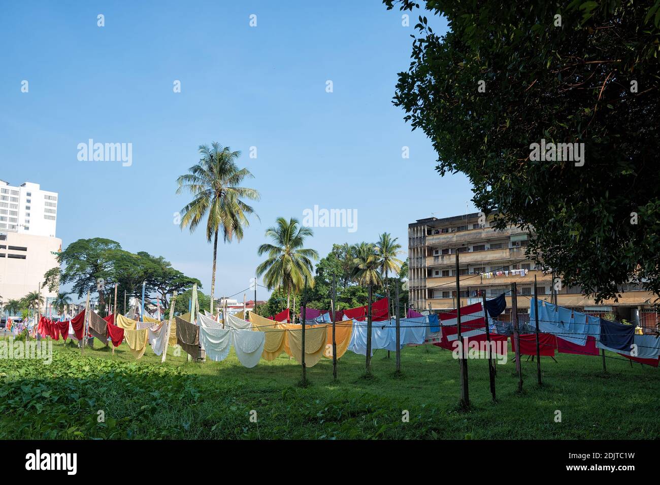 Traditional laundary, colorful towels and clothes hanging under the sun - Traditional cloth drying on sunny day Stock Photo