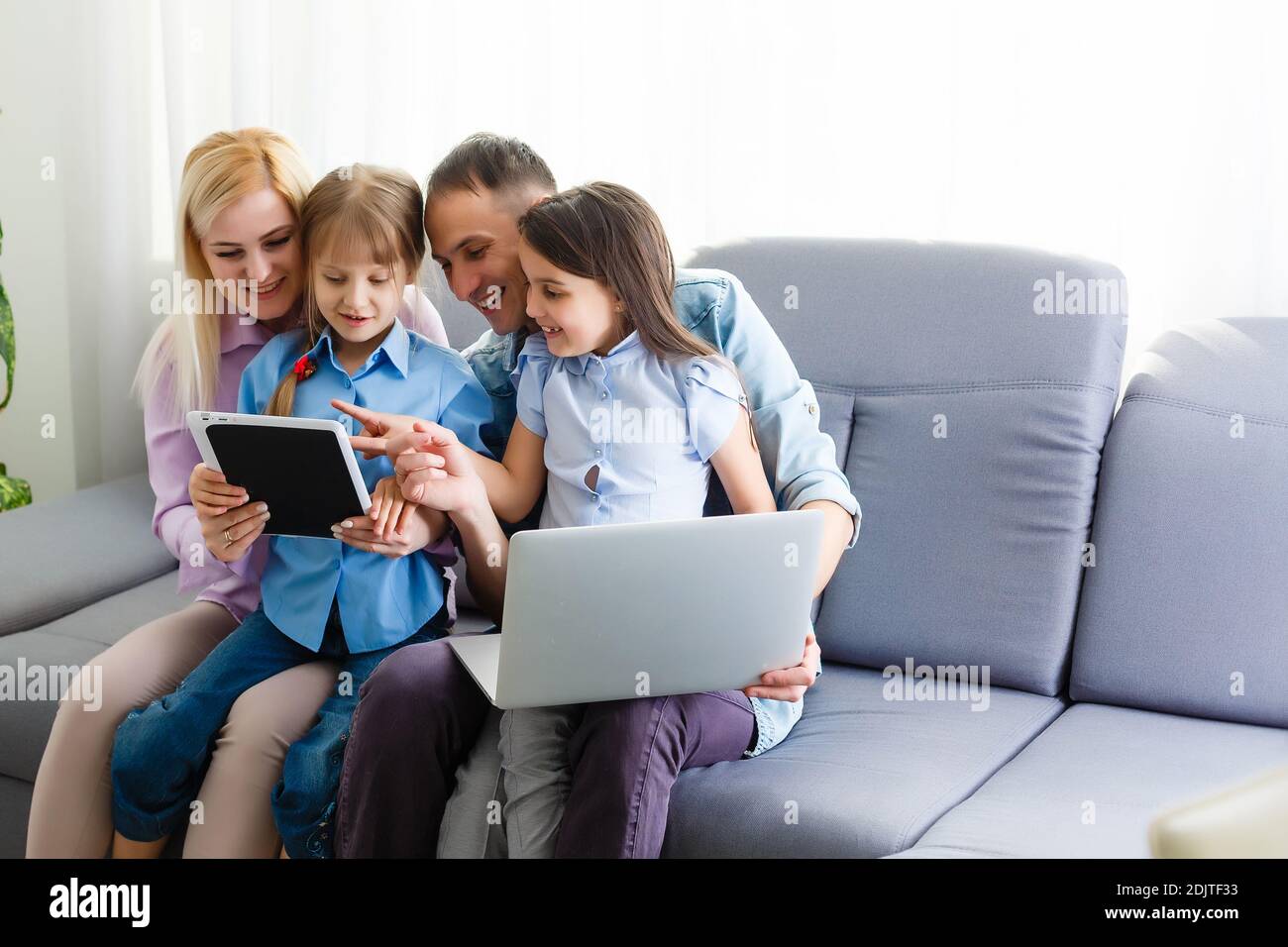 Family Working At Laptop With In Home Office Stock Photo - Alamy