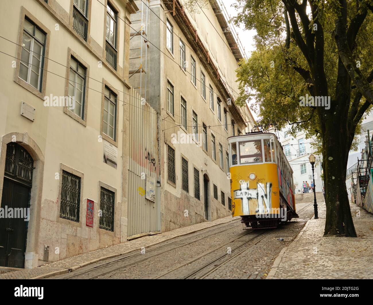 Tram going up hill in Lisbon Stock Photo