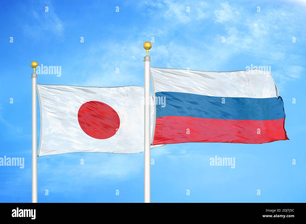 Japan and Russia two flags on flagpoles and blue cloudy sky Stock Photo ...