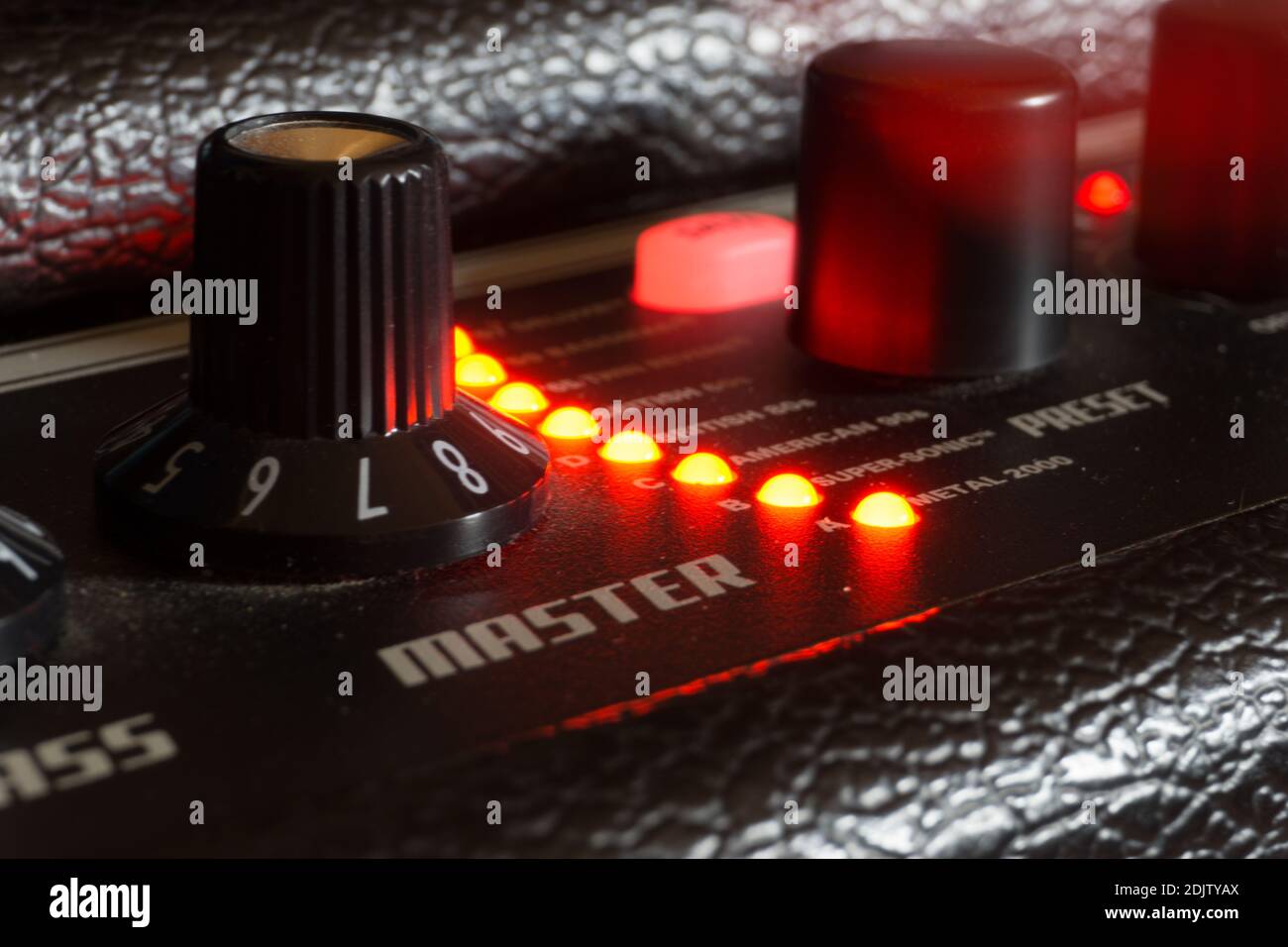 Detail of an amplifier for electric guitar with red lights Stock Photo