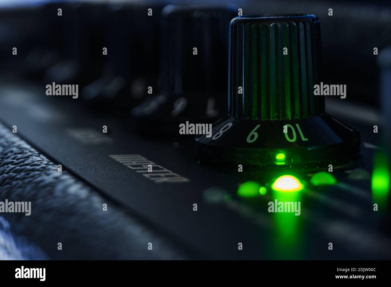 Detail of an amplifier for electric guitar with green lights Stock