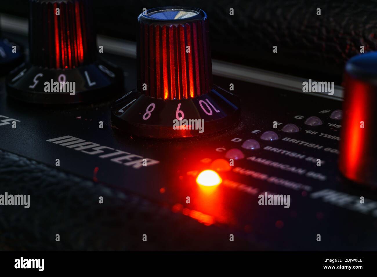 Detail of an amplifier for electric guitar with red lights Stock Photo Alamy