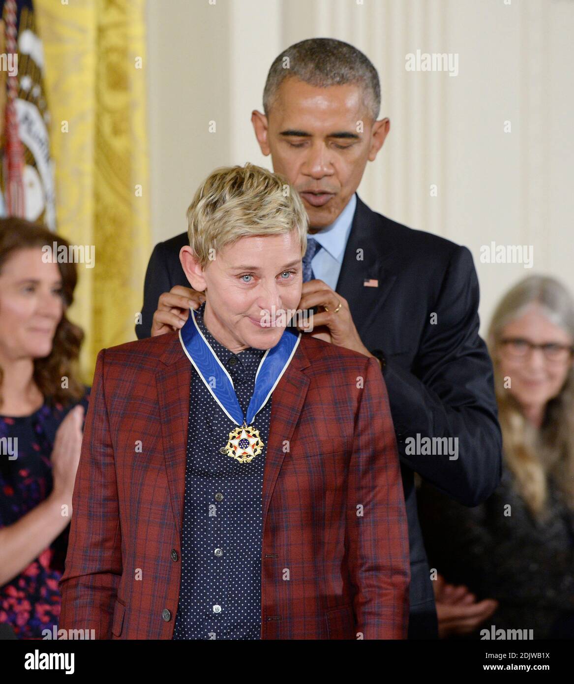 US President Barack Obama presents comedian Ellen DeGeneres with the  Presidential Medal of Freedom, the nation's highest civilian honor, during  a ceremony honoring 21 recipients, in the East Room of the White