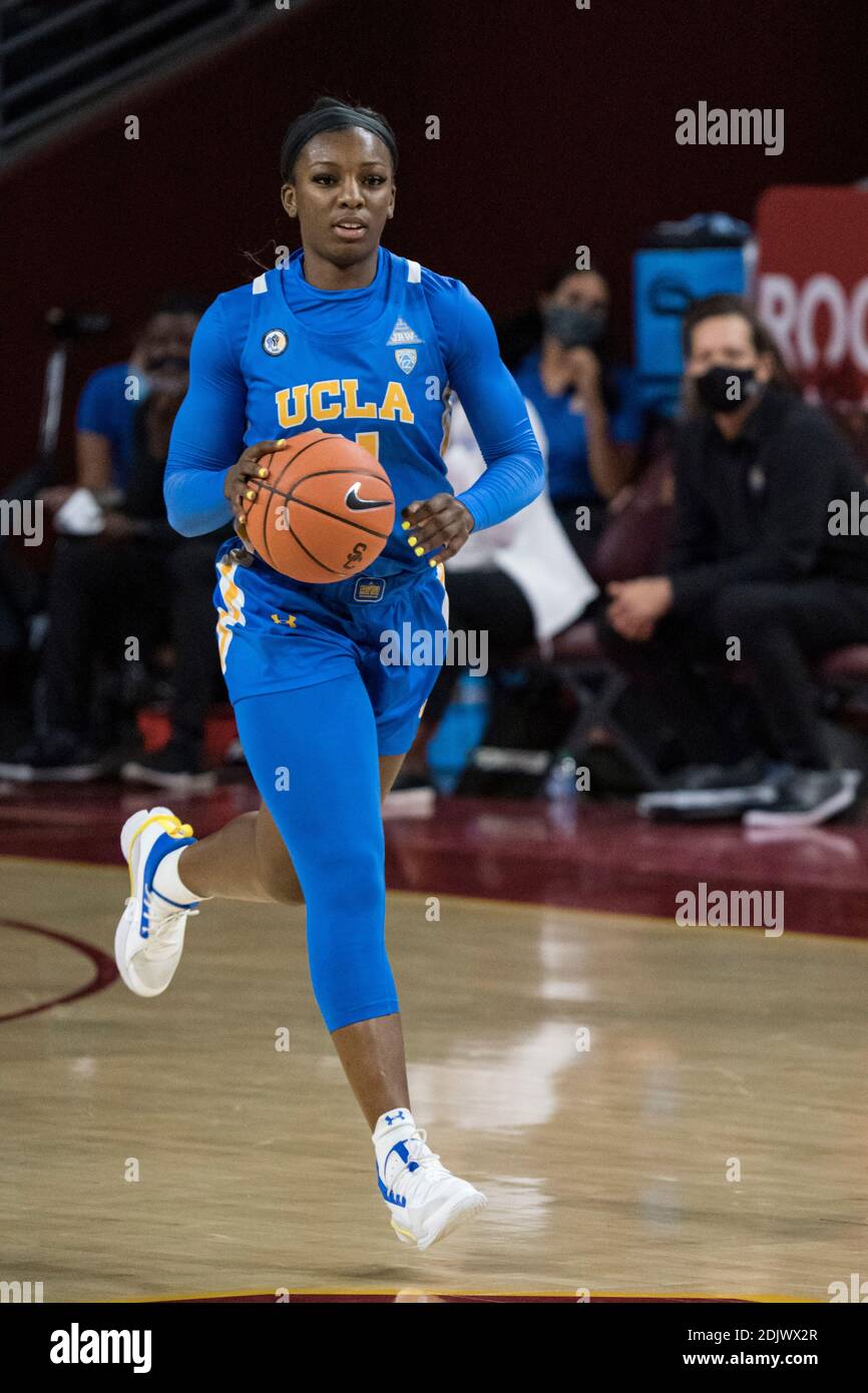UCLA Bruins forward Michaela Onyenwere (21) brings the ball up court during an NCAA college basketball game against the Southern California Trojans, S Stock Photo