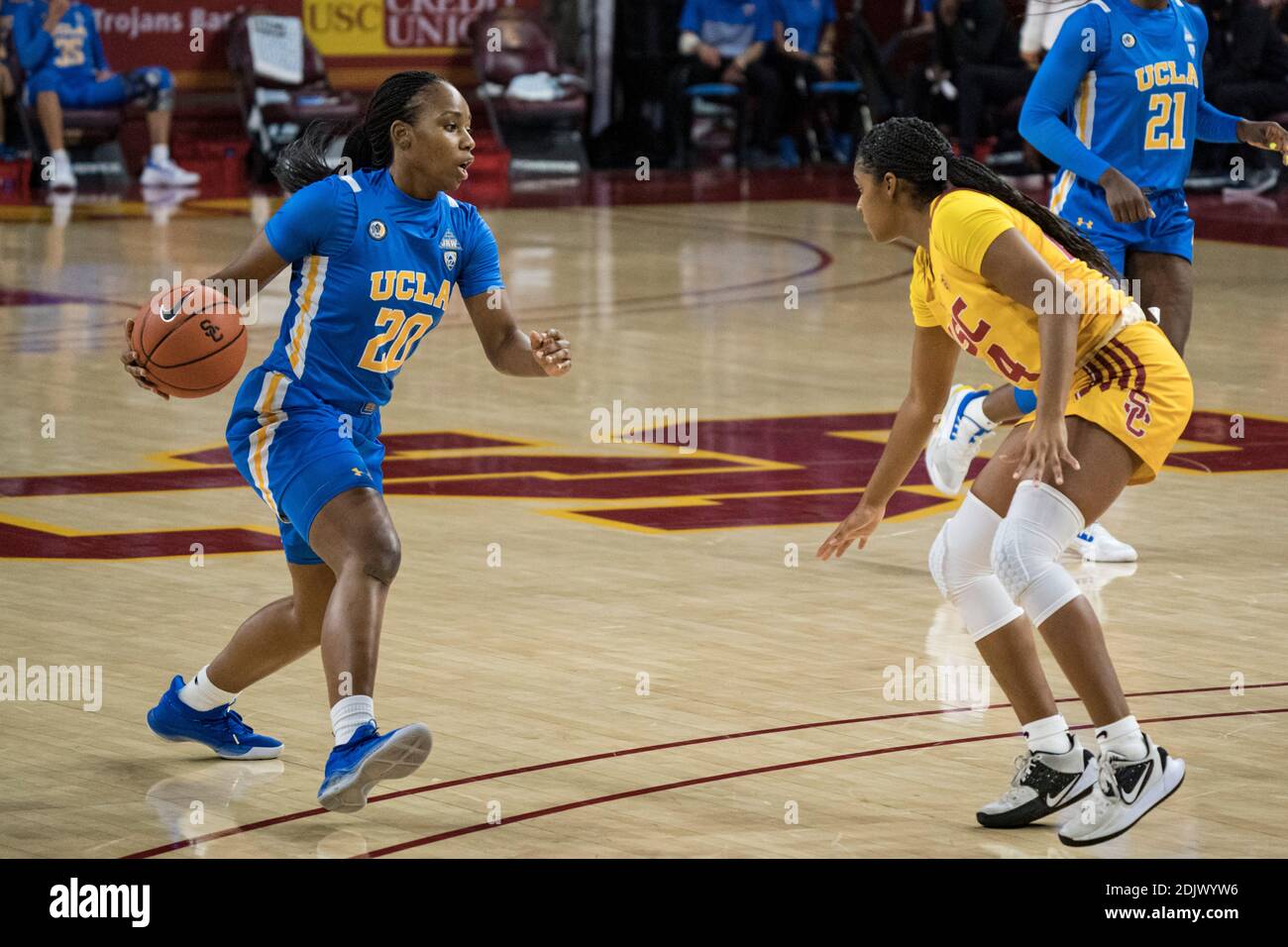 UCLA Bruins guard Charisma Osborne (20) is defended by Southern California Trojans guard Desire Caldwell (24) during an NCAA college basketball game, Stock Photo