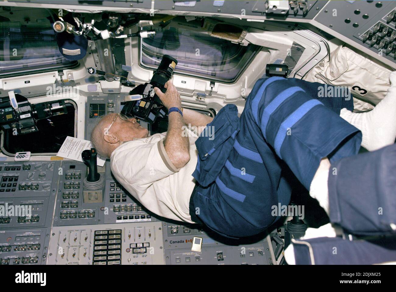 STS-95 Payload Specialist John Glenn positions himself to take photos from the Discovery's aft flight deck windows on Flight Day 3. Please note: Fees charged by the agency are for the agency 2019 ;s services only, and do not, nor are they intended to, convey to the user any ownership of Copyright or License in the material. The agency does not claim any ownership including but not limited to Copyright or License in the attached material. By publishing this material you expressly agree to indemnify and to hold the agency and its directors, shareholders and employees harmless from any loss, clai Stock Photo