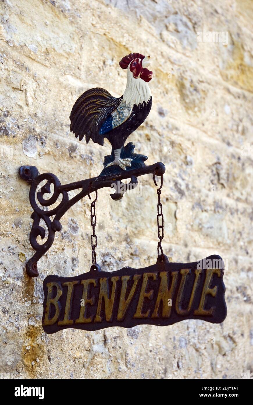 An iron rooster 'Bienvenue' (Welcome) sign at a traditional Normandy farm chateau near Utah Beach at Sainte-Marie-du-Mont, France. Stock Photo
