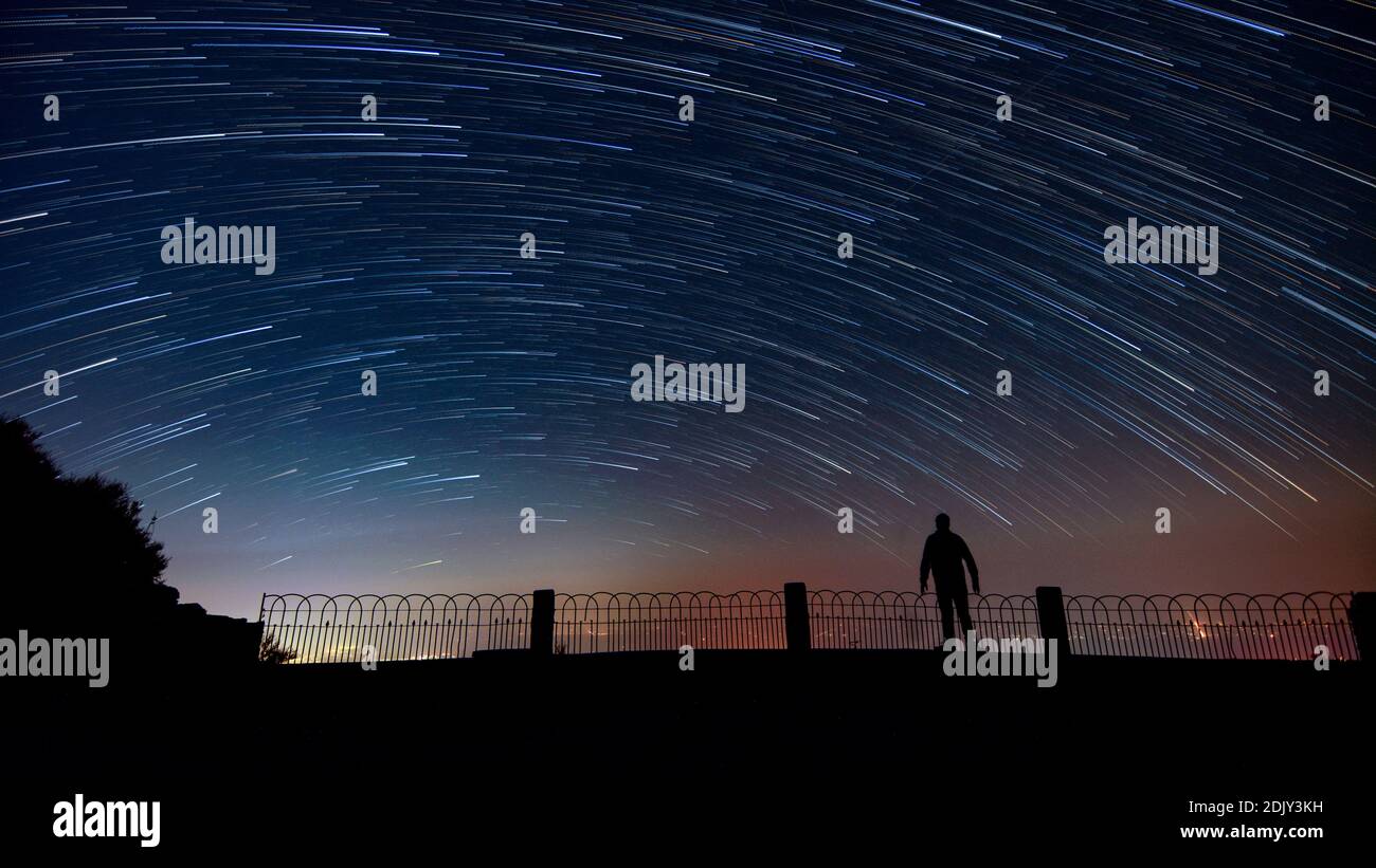 Full Length Of Silhouette Man Looking At Star Trails In Sky During ...