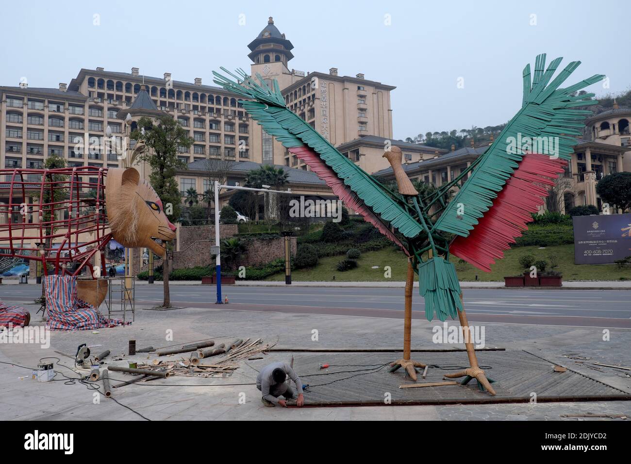 Exclusive. Workers finish the giant animals displayed in the city of Chishui.The Woo of Chishui is an art project elaborated by the artist Gad Weil in association with the city's tourist office to promote tourism in the region. The red color of the steel represents the red river that runs through Chishui and the green steel symbolizes the Tree Fern (Cibotium Barometz) and the bamboo very present in the area. Heads and feet of the five giant animals (a crane bird, a tiger, and not built yet: a monkey, a dolphin and a dinosaur) are made out of bamboo. The eco-friendly event is meant to invite pe Stock Photo