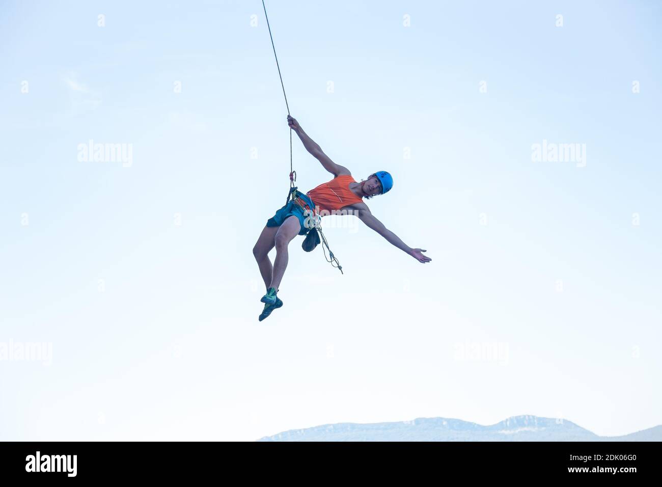 Low Angle View Of Man Hanging From Rope Against Clear Sky Stock Photo -  Alamy
