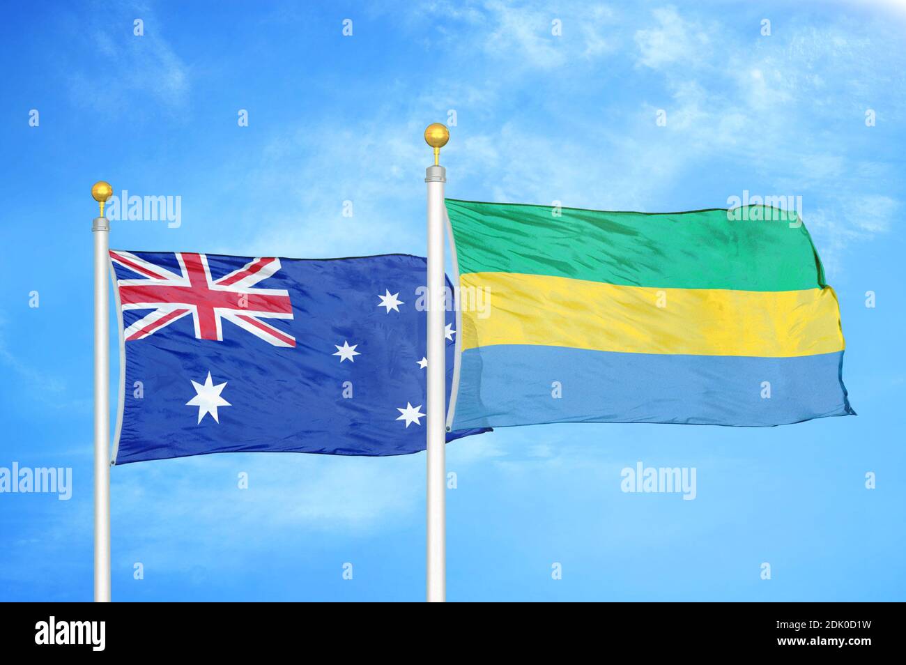 Australia and Gabon two flags on flagpoles and blue cloudy sky Stock Photo