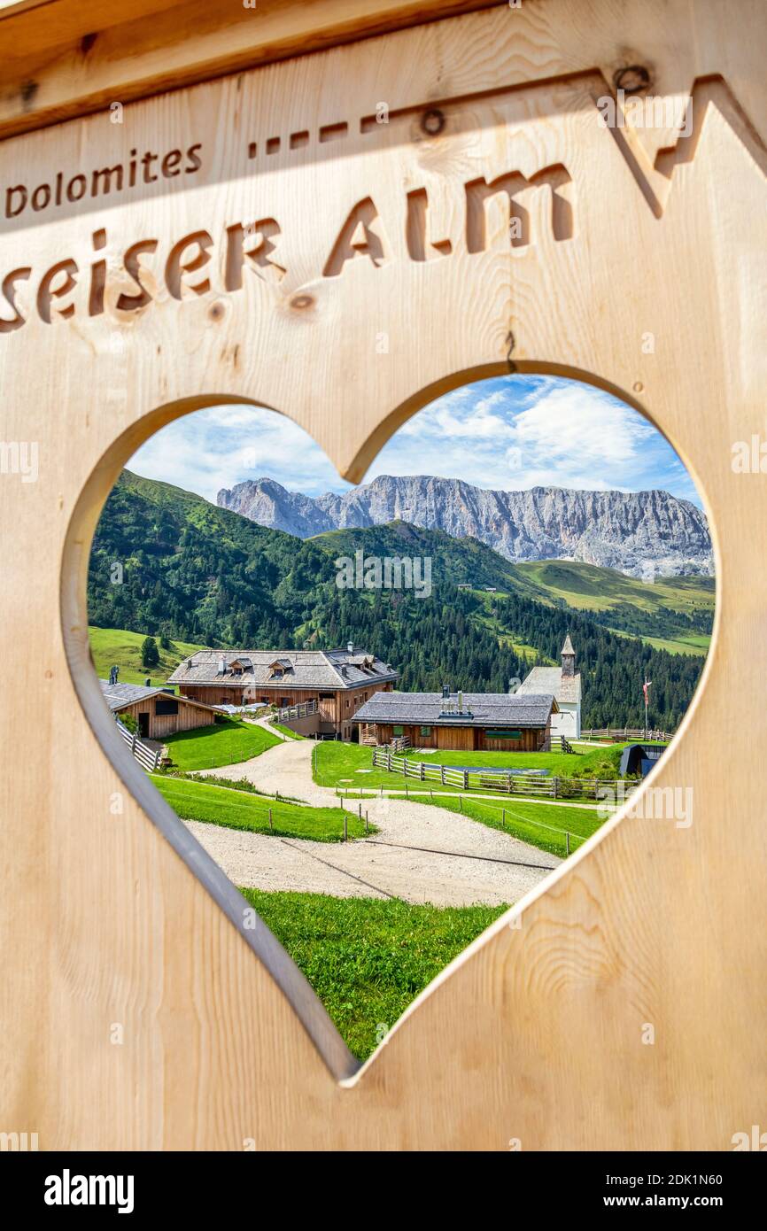 Zallinger Alm seen through a heart-shaped hole, Saltria, Seiser Alm, Dolomtes Bolzano, South Tyrol / Südtirol, Italy, Europe Stock Photo