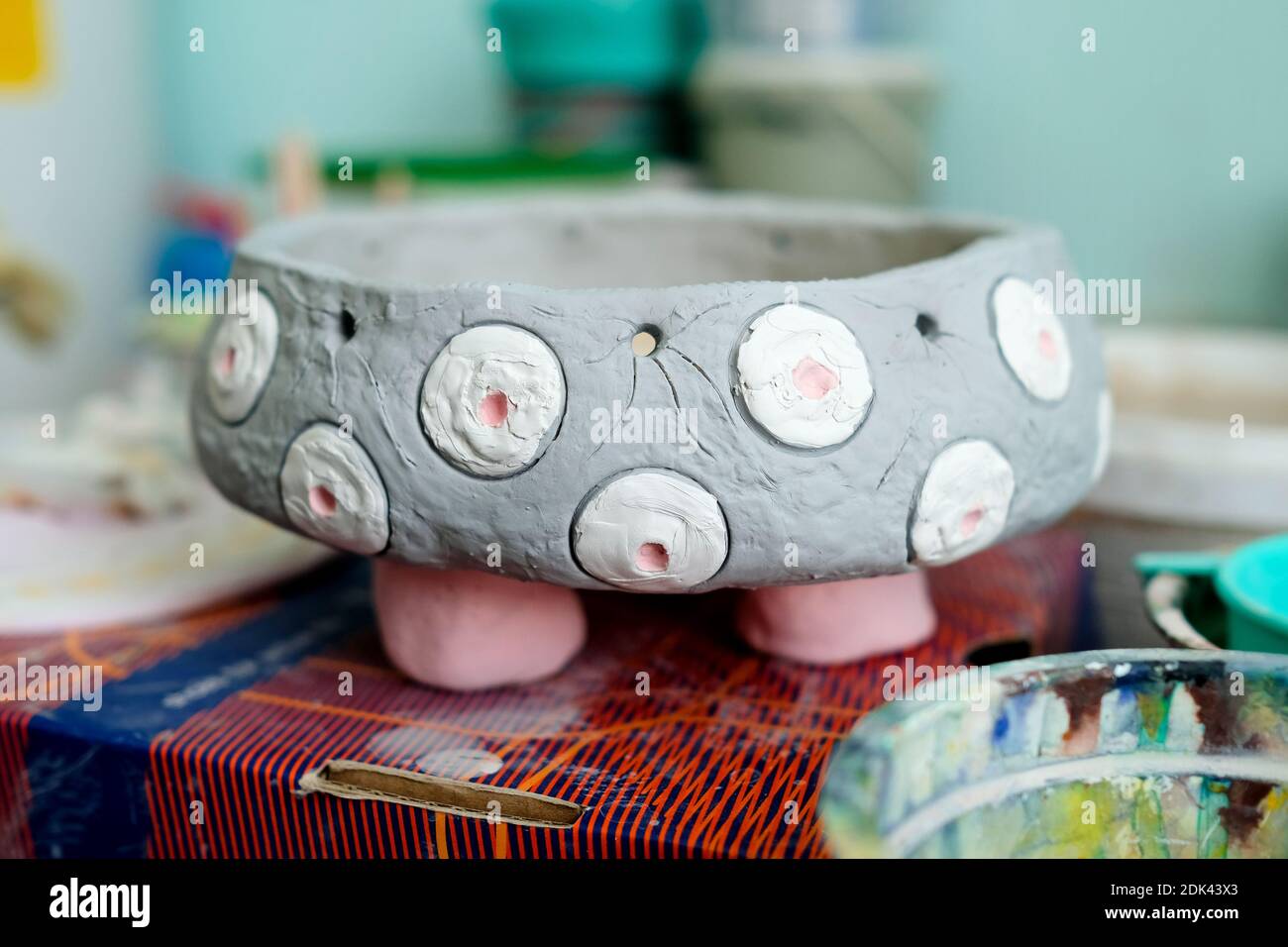 Raw clay product. Clay vase painted with paint. work Stock